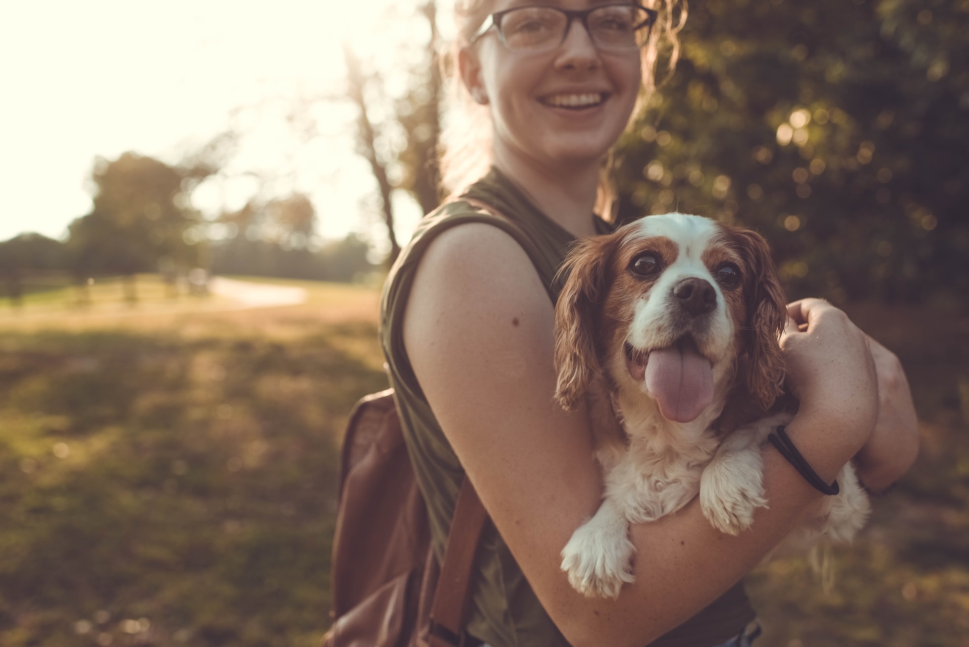 Woman smiling while holding her dog